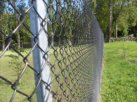 What causes corrosion of chain link fences